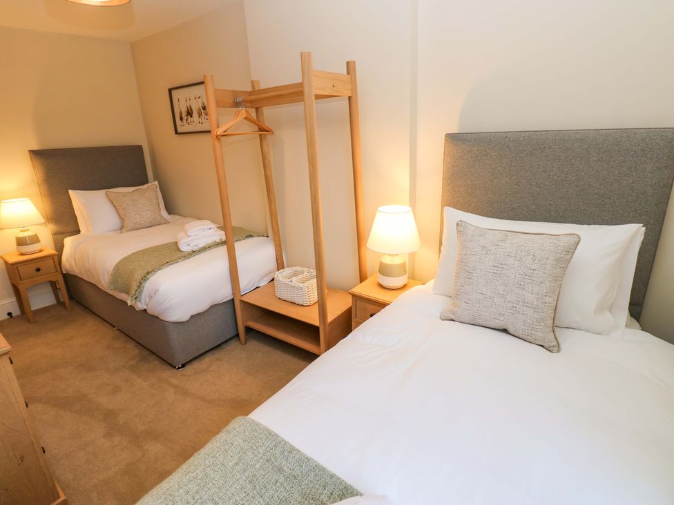 A bedroom with two beds and a lamp at Milford in Great Corby, Wetheral