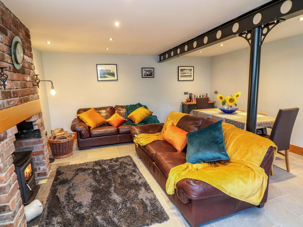A living room with a sofa and table at 6 Brook Court Thulston near Derby
