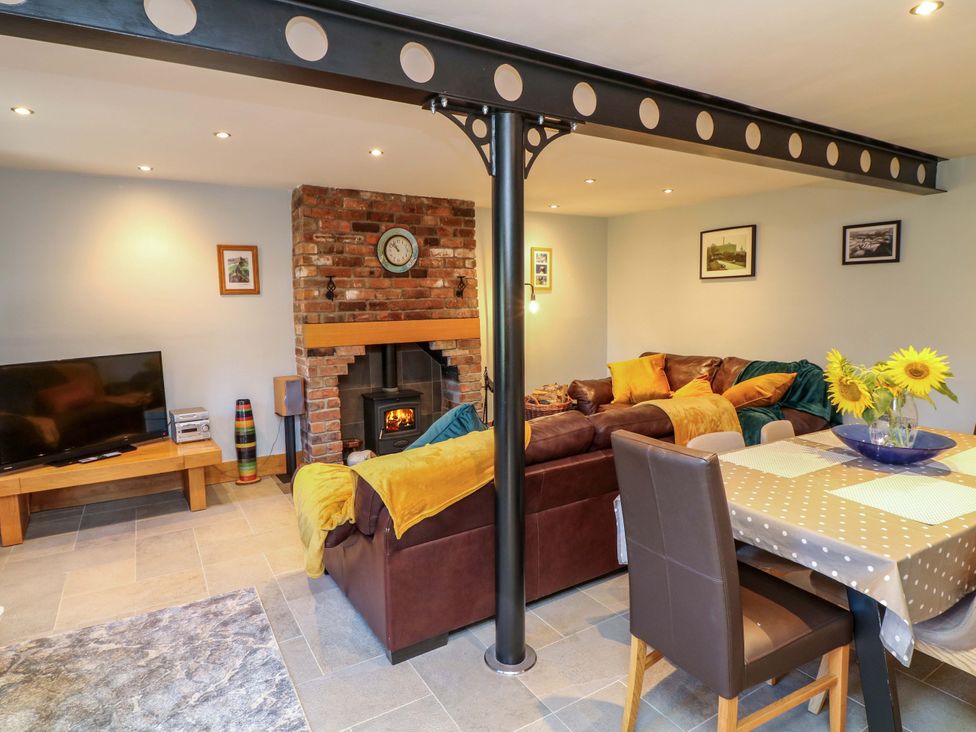 A living room with a television and sofa at 6 Brook Court Thulston near Derby