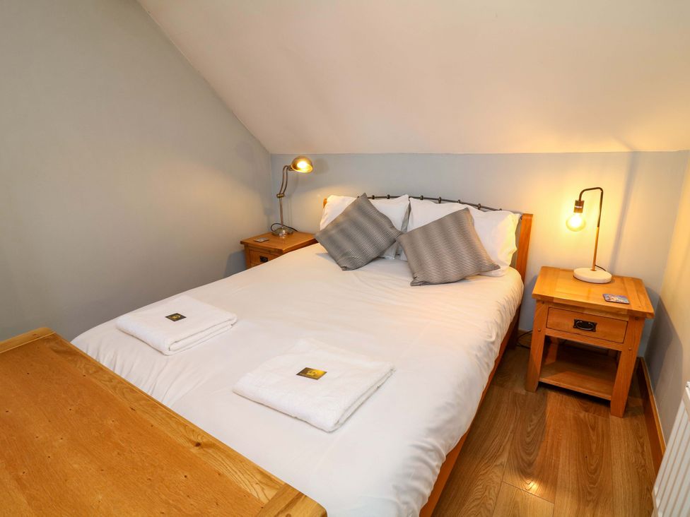 A bedroom with a bed and bedside table at 6 Brook Court Thulston near Derby