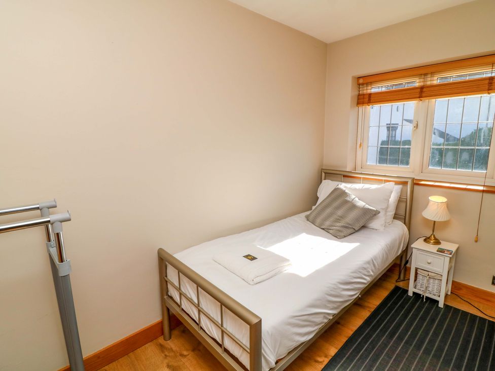 A bedroom with a bed and lamp at 6 Brook Court in Thulston near Derby