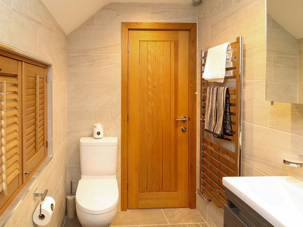 A bathroom with a toilet and sink at 6 Brook Court Thulston near Derby