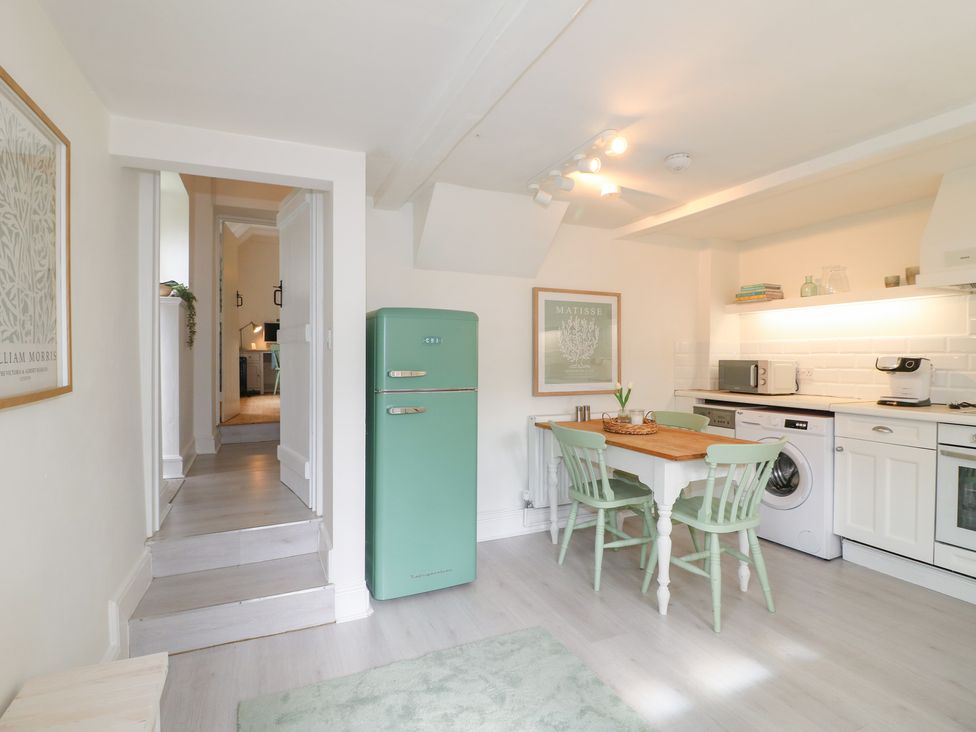 A kitchen with table and chairs at Pigwig Cottage