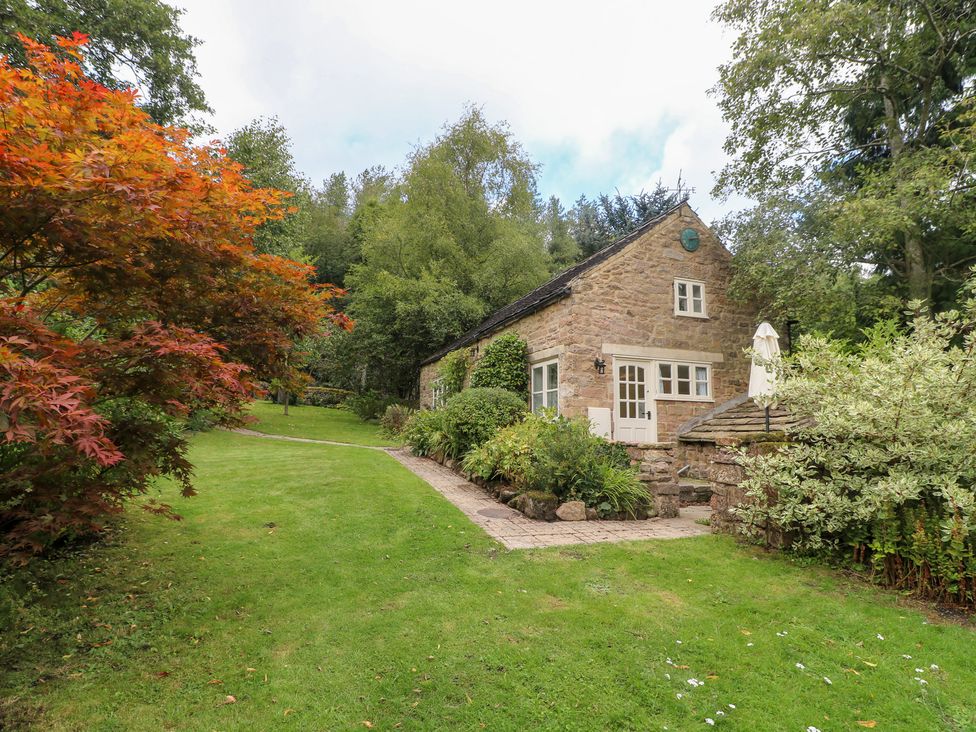 A cottage with garden and pathway at Pigwig Cottage