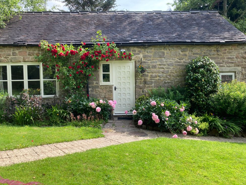 A cottage with flowers in front at Pigwig Cottage Longway Bank near Crich