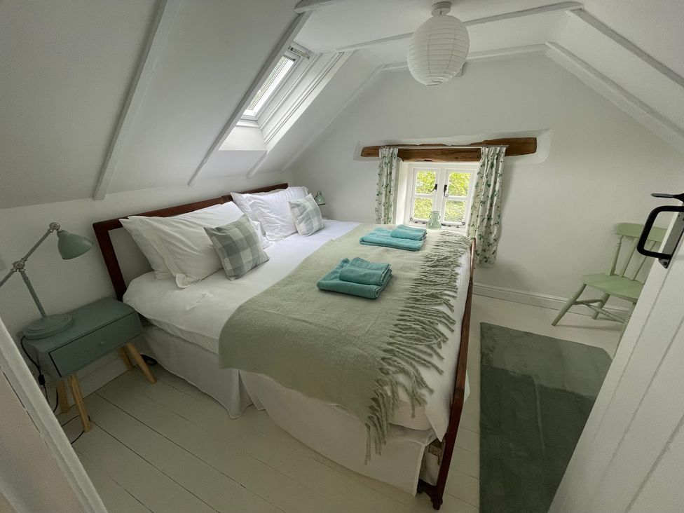A bedroom with a double bed and a window at Pigwig Cottage in Longway Bank near Crich