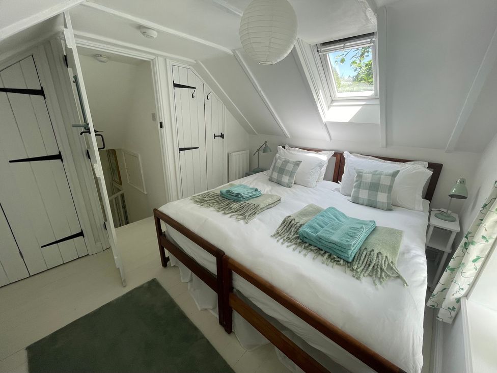 A bedroom with a double bed and window at Pigwig Cottage Longway Bank near Crich
