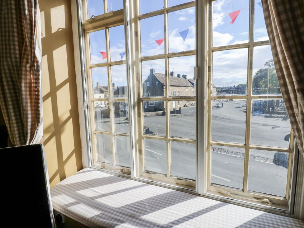 A window with a view of buildings and road at Ewe Cottage in Ripon