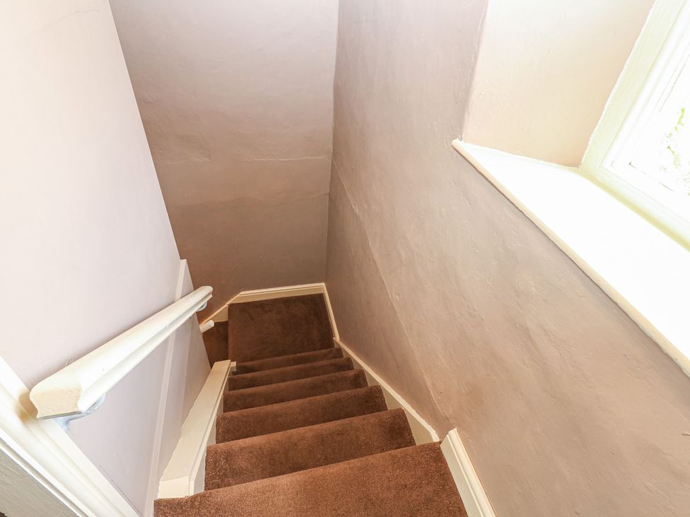 A staircase with steps and a handrail at Ewe Cottage in Masham
