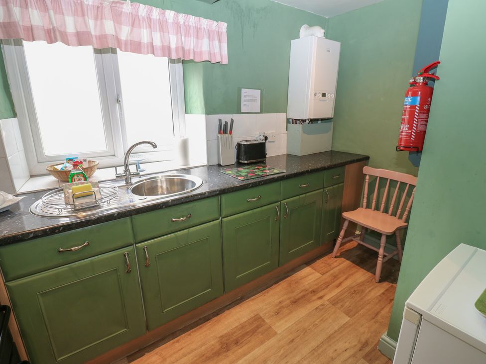 A kitchen with sink and countertop at Ewe Cottage in Masham