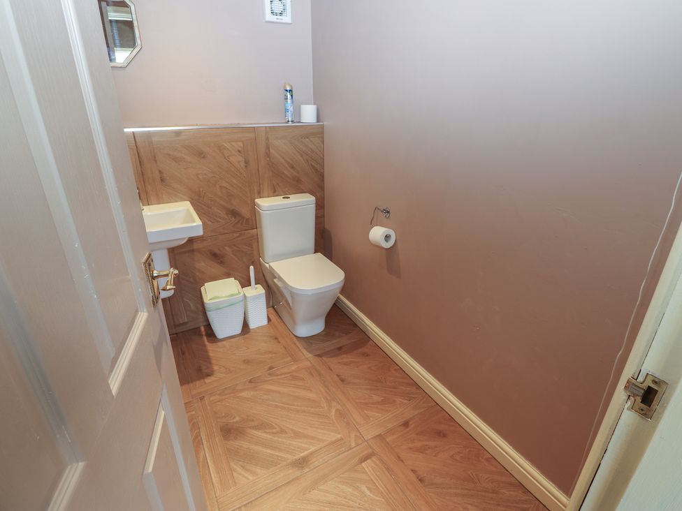 A bathroom with a toilet and sink at Ewe Cottage in Masham