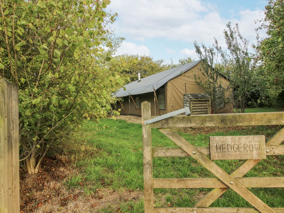 A tent viewed through a wooden gate at Hedgerow in Bewdley