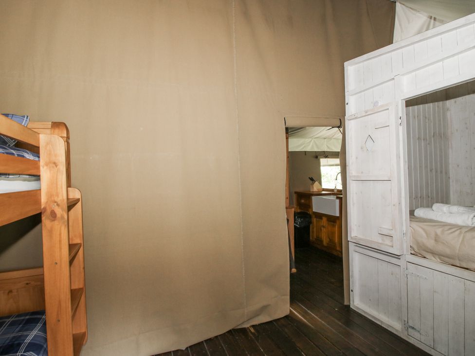 A bedroom with a bunk bed and a cabinet at Hedgerow in Bewdley