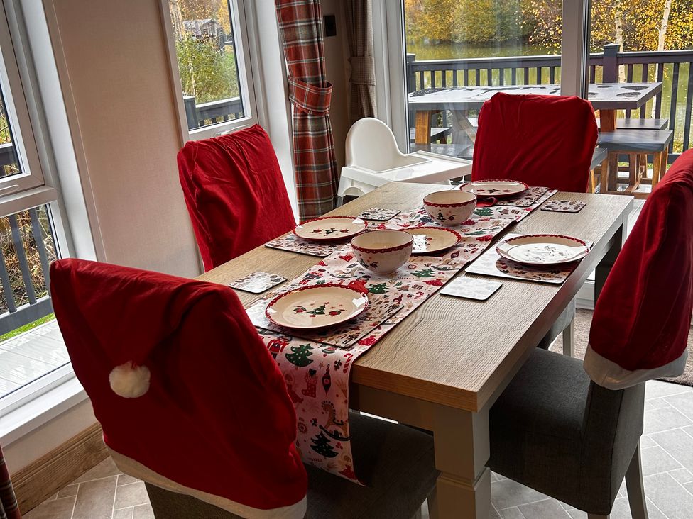 A dining room with a table set for a meal at Lakewood Retreat in Woodhall Spa