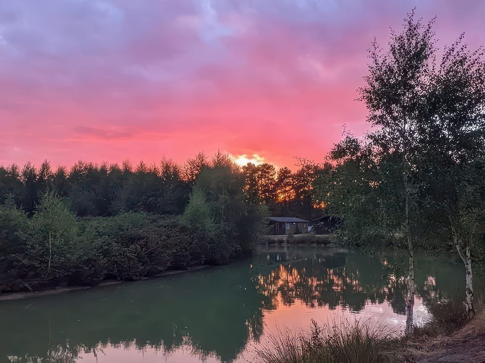 A scenic view of water and trees at Lakewood Retreat in Woodhall Spa