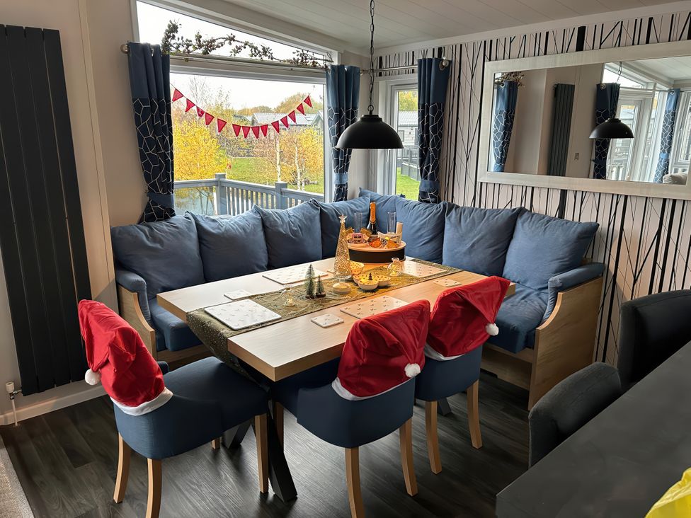 A dining room with a table set for decoration at Hotchkin Lodge in Woodhall Spa