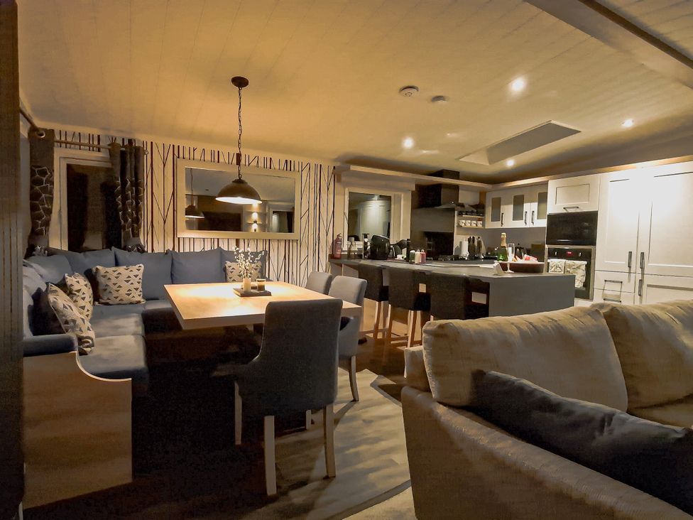 A kitchen with a dining table and chairs at Hotchkin Lodge in Woodhall Spa