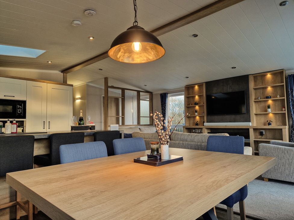 A dining room with a table and chairs at Hotchkin Lodge in Woodhall Spa