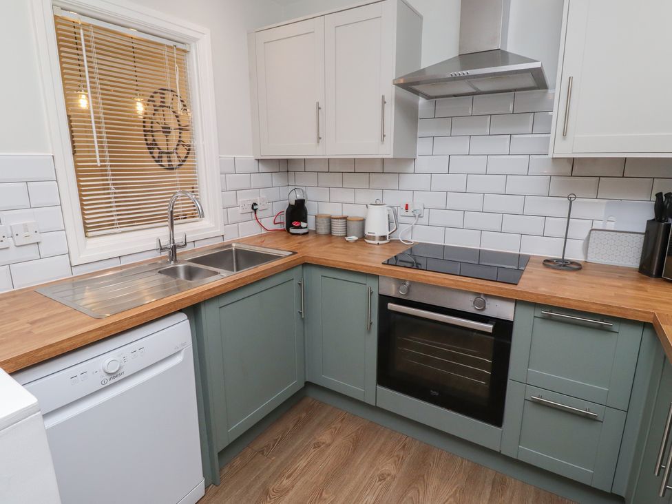 A kitchen with sink, oven, and countertop at Nobles Nook in Seahouses