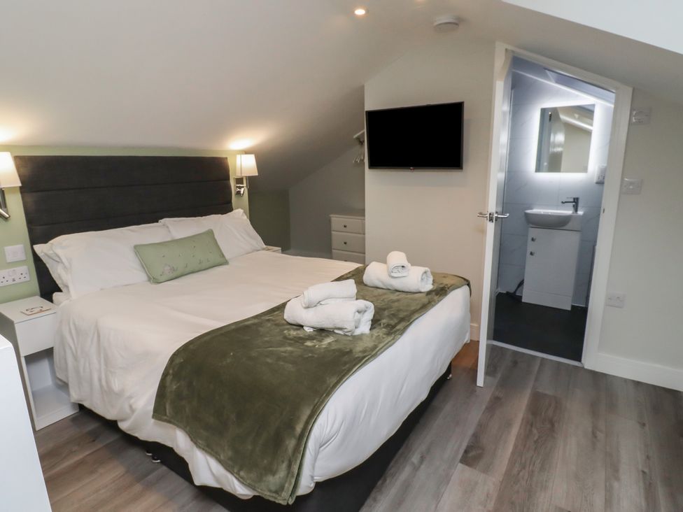 A bedroom with a bed and television at Nobles Nook in Seahouses