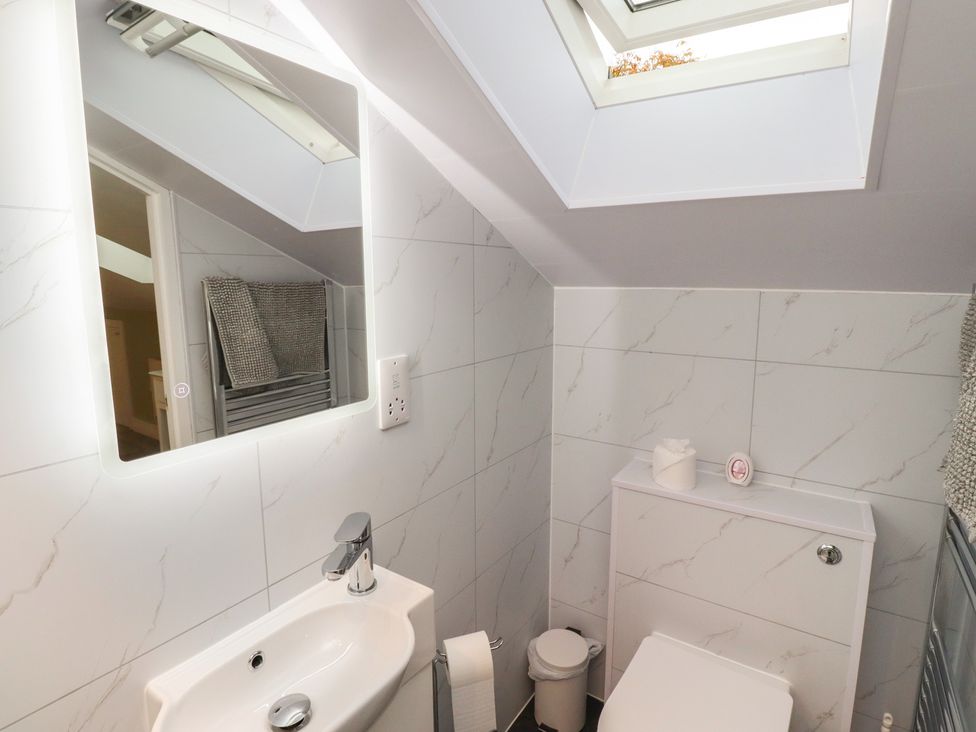 A bathroom with sink and toilet at Nobles Nook in Seahouses