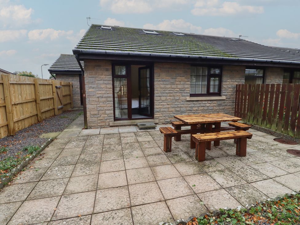 An outdoor area with a table and benches at Nobles Nook in Seahouses