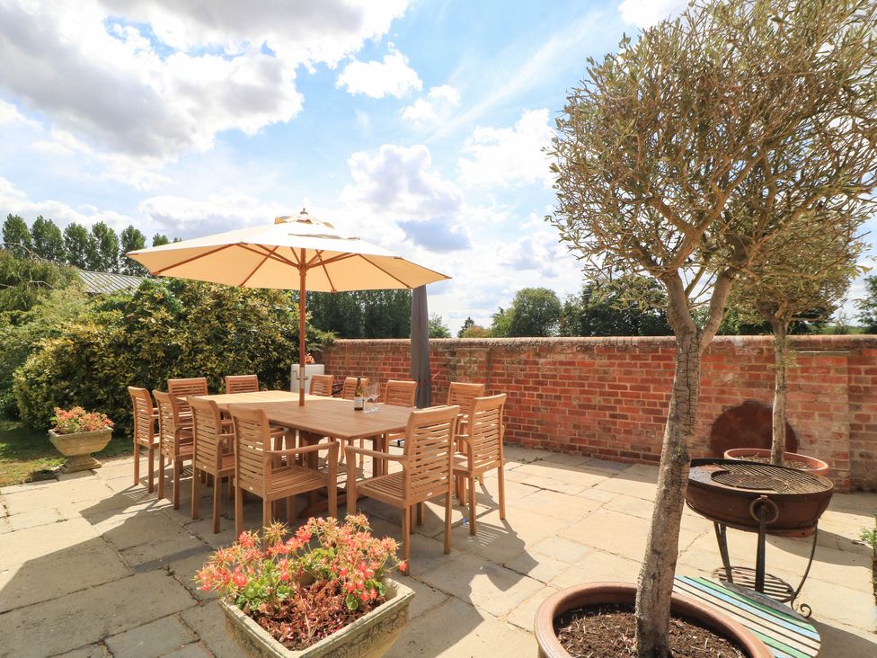 An outdoor dining area with a table and chairs at The Mount in Chippenham