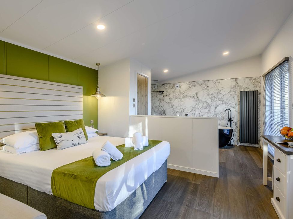 A bedroom with a bed and a bathtub at Somersby (Pet) in Louth