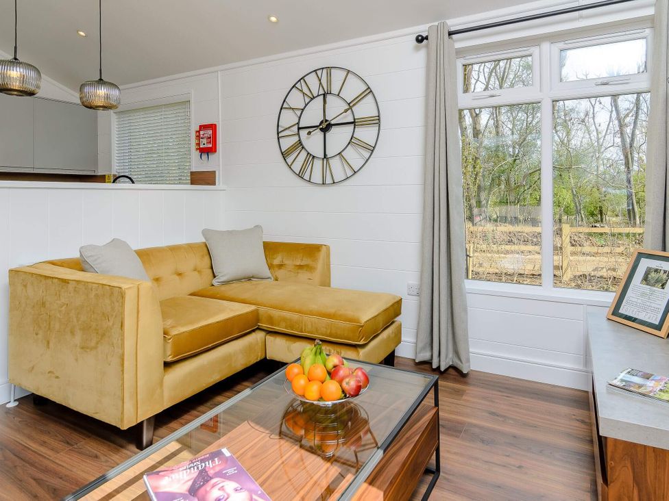 A living room with a sofa, coffee table and fruit bowl at The Woodnewton in Wansford