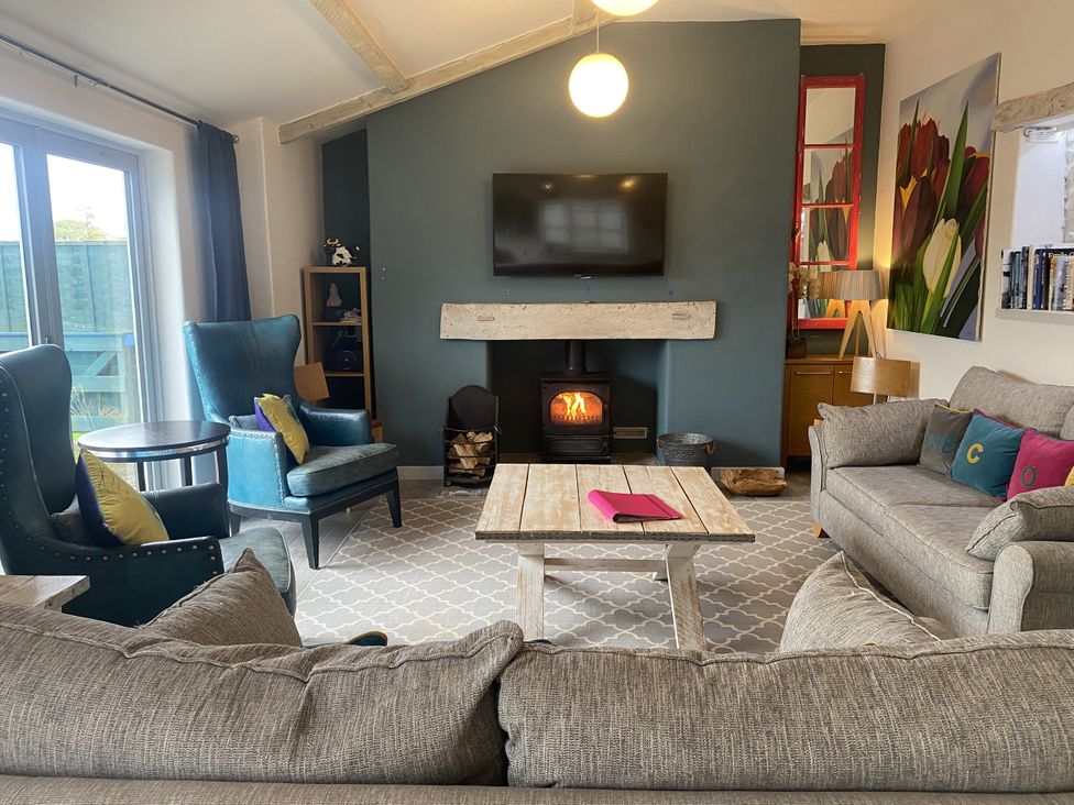 A living room with seating and a television at The Cow Shed in Bishopswood