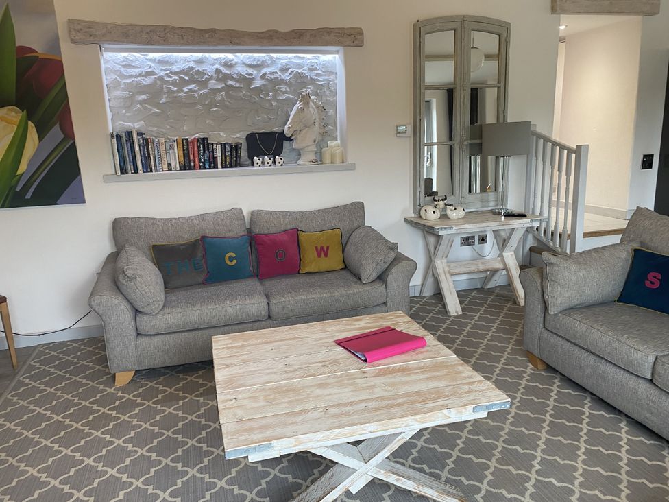 A living room with a sofa and coffee table at The Cow Shed in Bishopswood