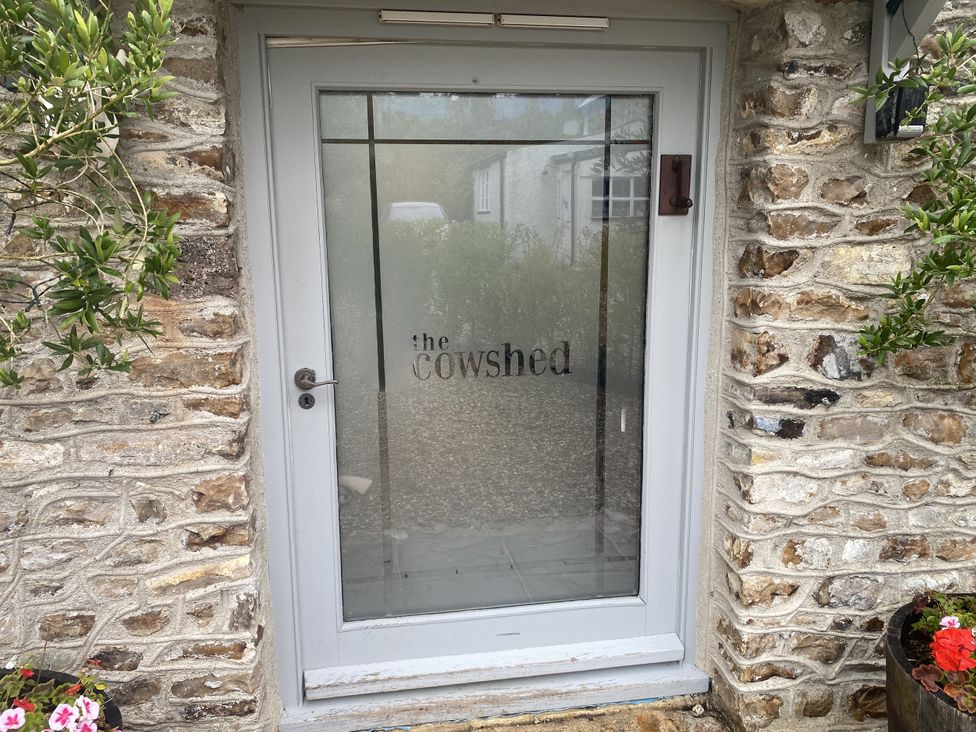 An entrance door with stone wall at The Cow Shed in Bishopswood