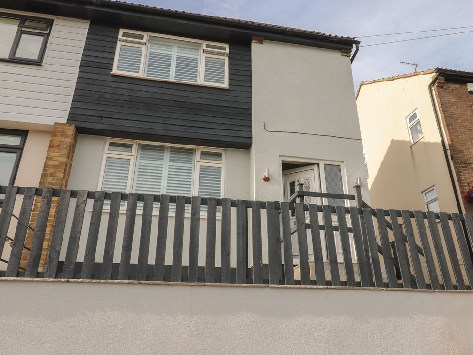 A house exterior with windows and a fence at 42 Windsor Avenue