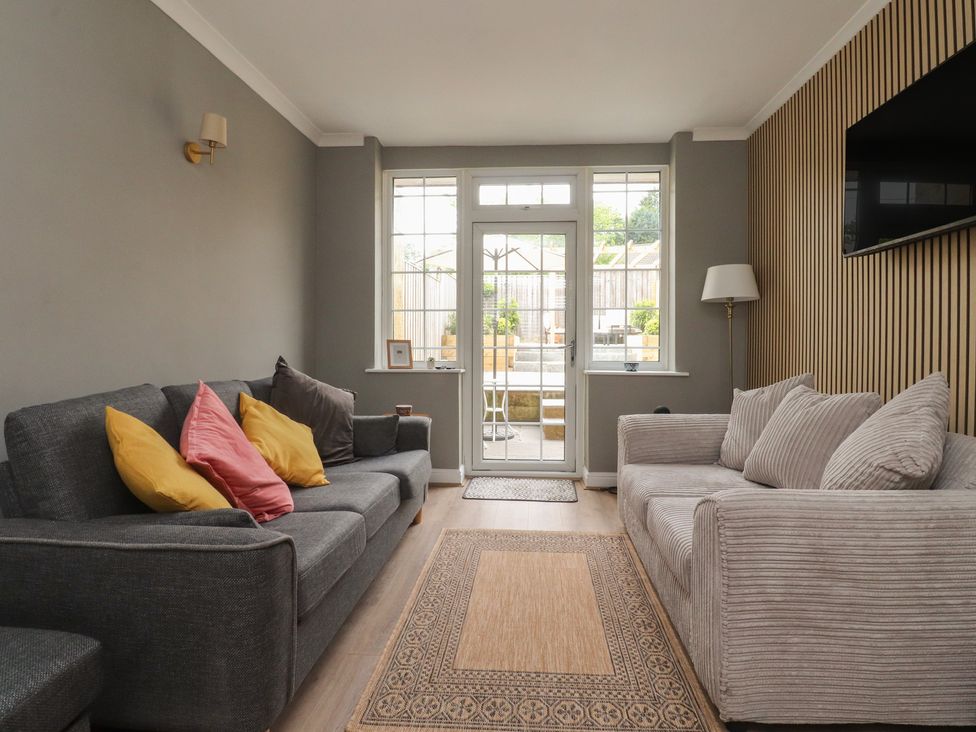 A living room with sofas and a door leading outside at 42 Windsor Avenue 