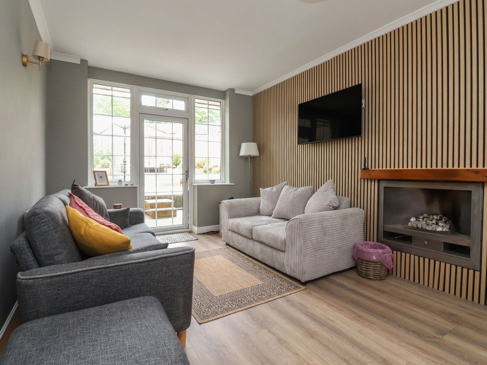 A living room with a sofa and armchair at 42 Windsor Avenue