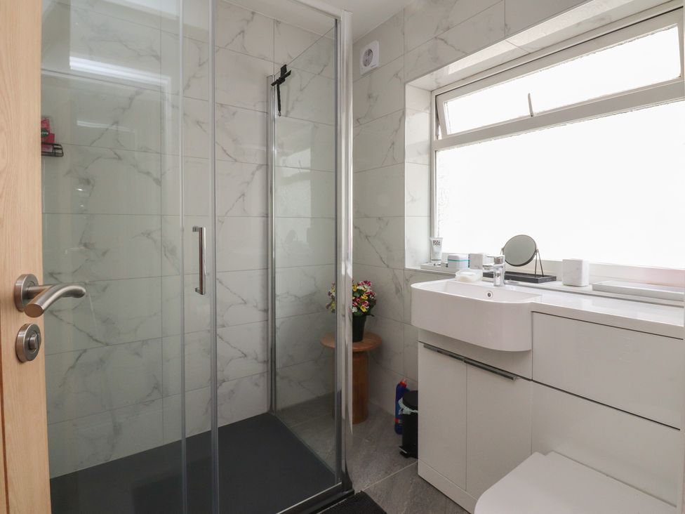 A bathroom with a shower and vanity at 42 Windsor Avenue