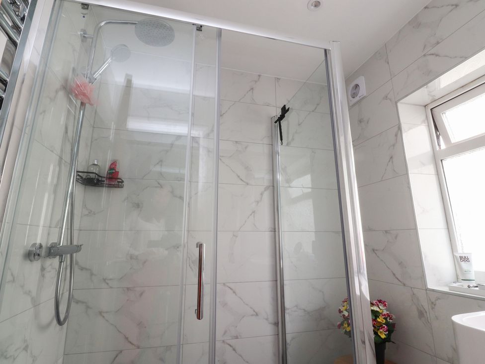 A shower with a glass door and a window in 42 Windsor Avenue 