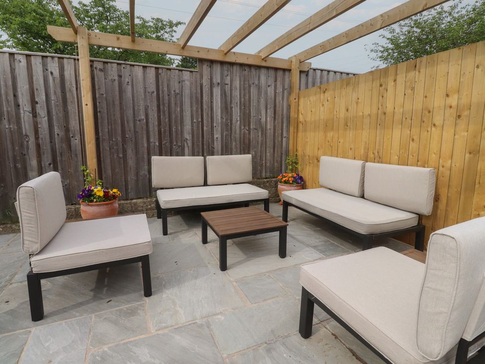 An outdoor seating area with sofas and a coffee table at 42 Windsor Avenue