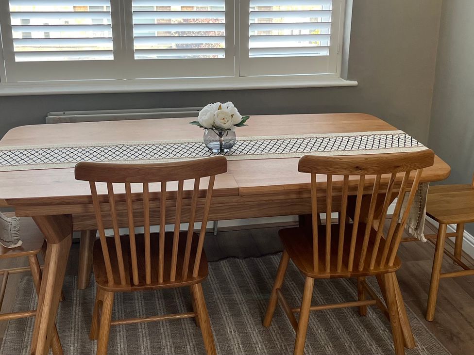 A dining room with a table and chairs at Shepherd's Lodge in Skipton