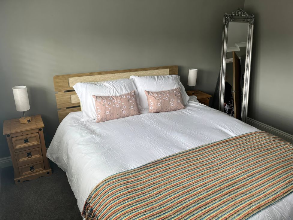 A bedroom with a bed and nightstands at Shepherd's Lodge in Skipton