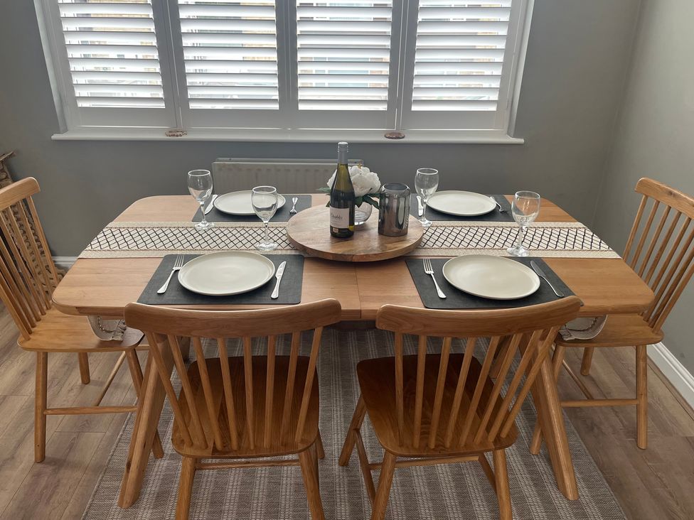 A dining room with a table set for four at Shepherd's Lodge in Skipton