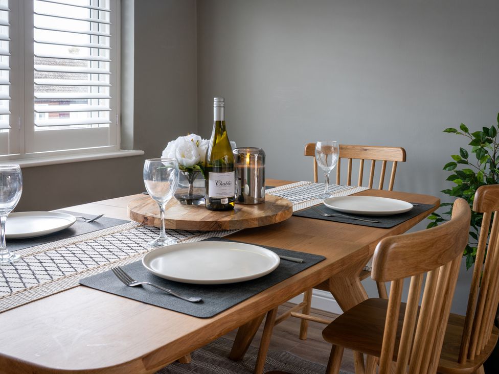 A dining room with a table set for dining at Shepherd's Lodge in Skipton