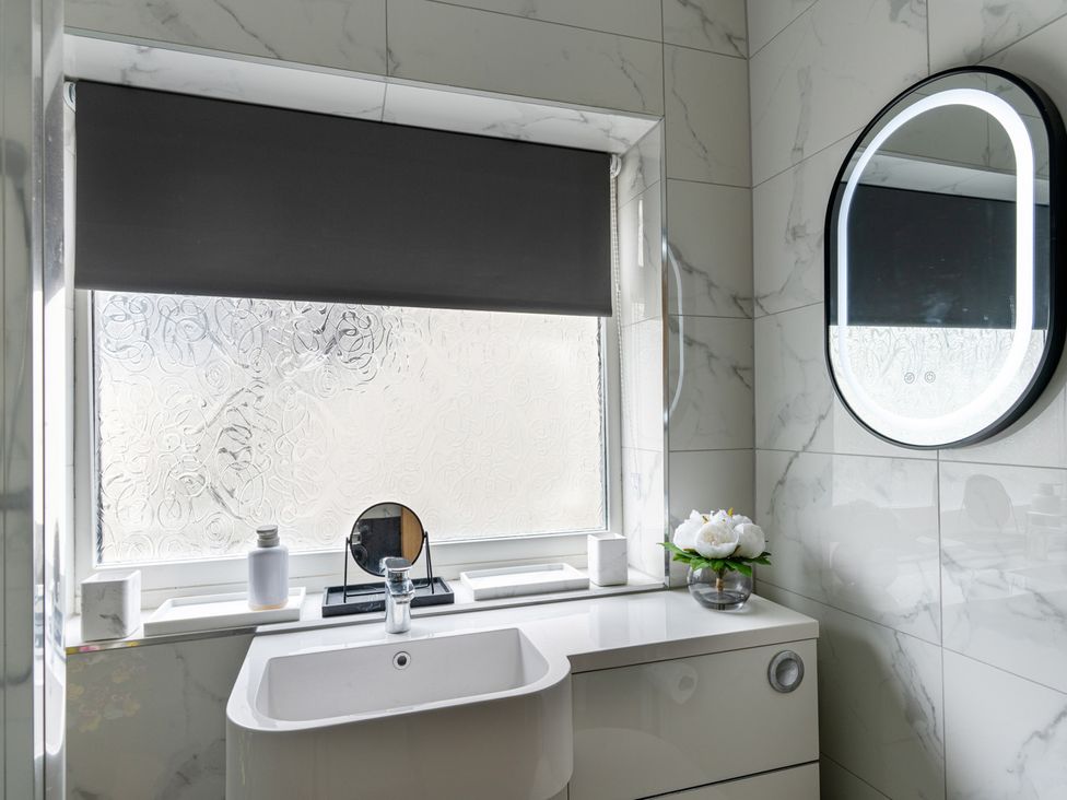 A bathroom with a sink and mirror at Shepherd's Lodge in Skipton