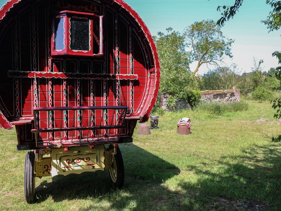A gypsy caravan in a grassy area at The Bowtop Gypsy Caravan in Eye