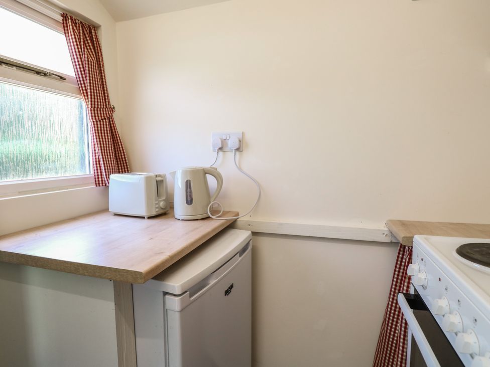 A kitchen with appliances including a kettle and toaster at The Bowtop Gypsy Caravan in Eye
