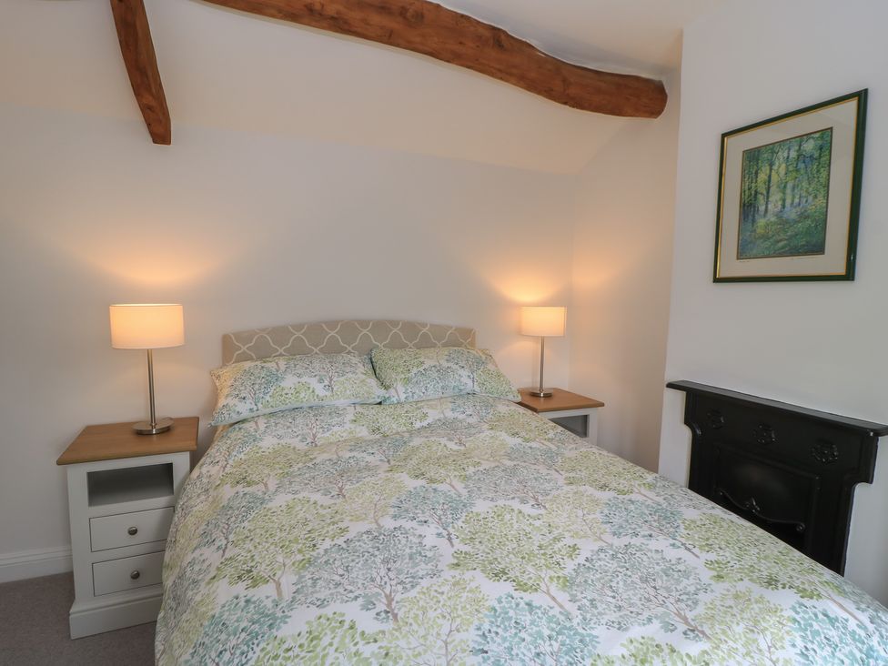 A bedroom with a bed and bedside tables at The Cottage in Ashton Keynes
