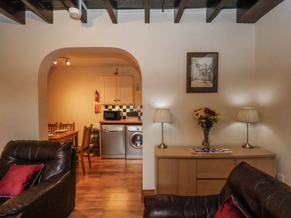 A living room with a view into the kitchen at 2 High Stakesby Cottages in Whitby
