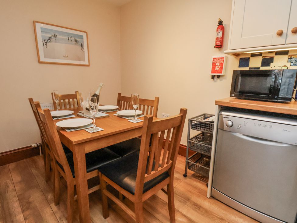 A dining room with a table and chairs at 2 High Stakesby Cottages in Whitby
