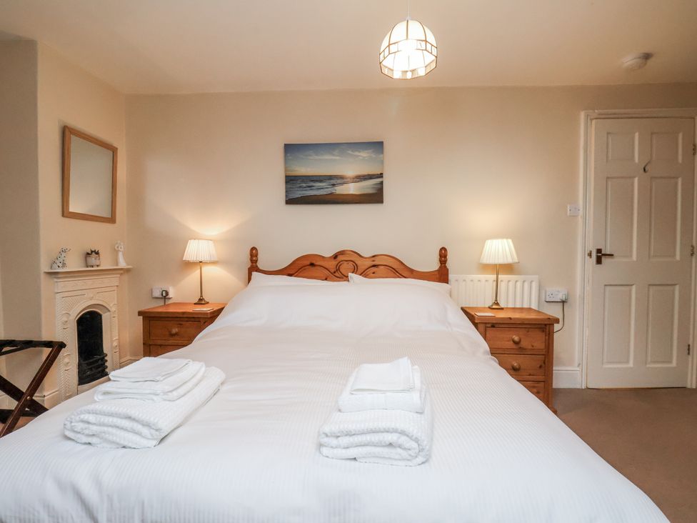 A bedroom with a bed and bedside lamps at 2 High Stakesby Cottages in Whitby