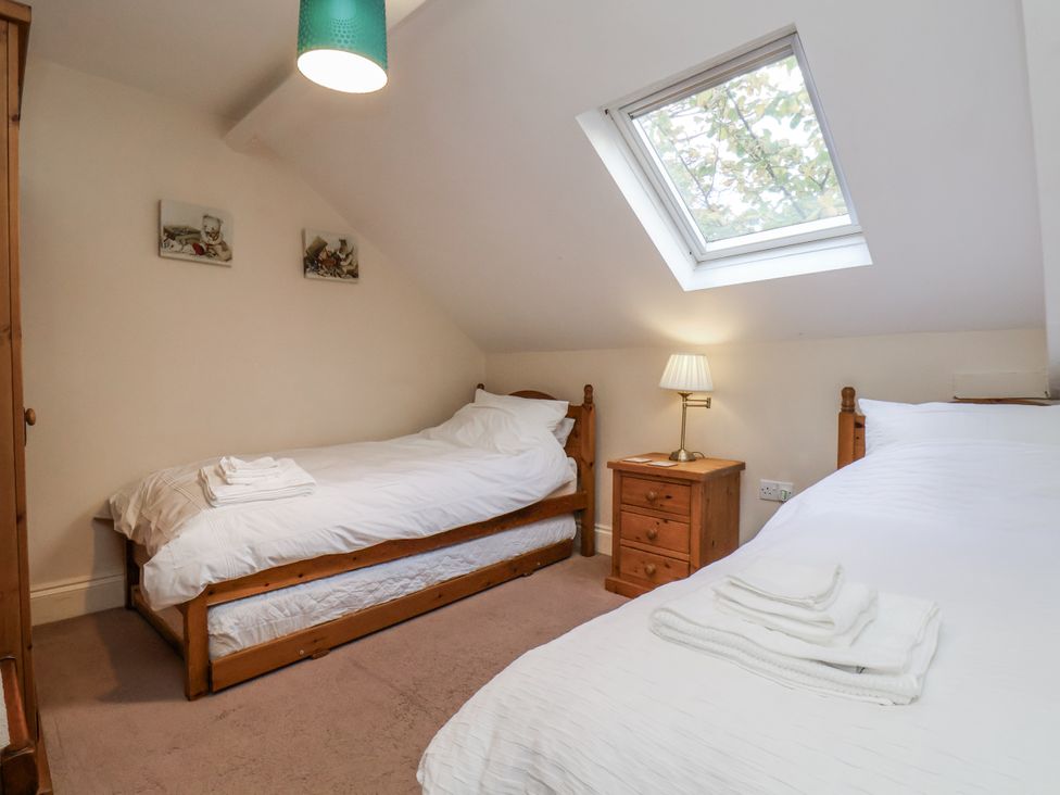 A bedroom with two beds and a nightstand at 2 High Stakesby Cottages in Whitby